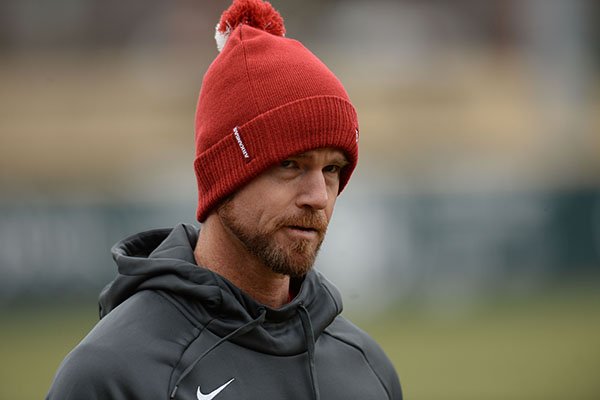 Arkansas pitching coach Matt Hobbs speaks to his players Friday, Jan. 25, 2019, during practice at Baum Stadium in Fayetteville.