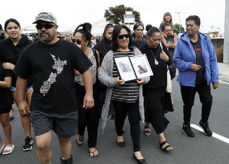 Families of victims of the White Island volcano eruption arrive back at the wharf Thursday after attending a blessing at sea before recovery operations begin off the coast of Whakatane, New Zealand.