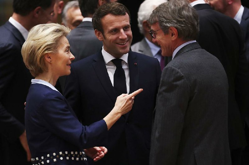 European Council President Ursula von der Leyen speaks Thursday with French President Emmanuel Macron (center) and European Parliament President David Sassoli during a meeting at an EU summit in Brussels.