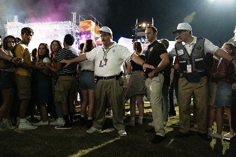 Clint Eastwood turns the story of rent-a-cop Richard Jewell (Paul Walter Hauser, in white shirt), who discovered a pipe bomb minutes before it exploded in Atlanta’s Centennial Park during the 1996 Olympic Games and likely saved dozens of lives, into a political morality play in his latest film. 