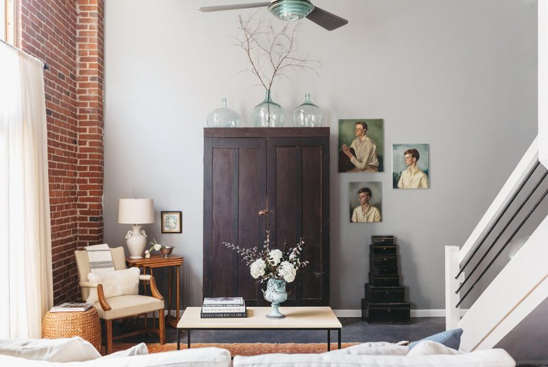 A vintage wardrobe from the 1800s serves as a focal point and adds storage in this Florence, Alabama, living room featured in Kim Leggett's book "City Farmhouse Style." 
(Photo by Alissa Saylor)