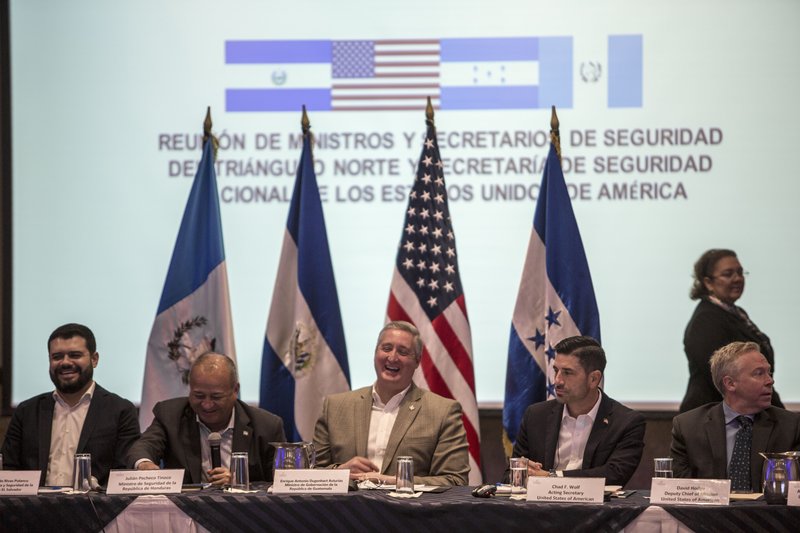 Salvadoran Minister of Justice and Security Rogelio Eduardo Rivas, left, Honduran Minister of Security Julian Pacheco, second left, Guatemalan Interior Minister Enrique Degenhart, center, Acting Secretary of Homeland Security Chad F. Wolf, second right, and U.S. Deputy chief of mission David Hodge laugh during a conference of minters in Guatemala City, Thursday, Dec. 12, 2019. (AP Photo/ Oliver de Ros)