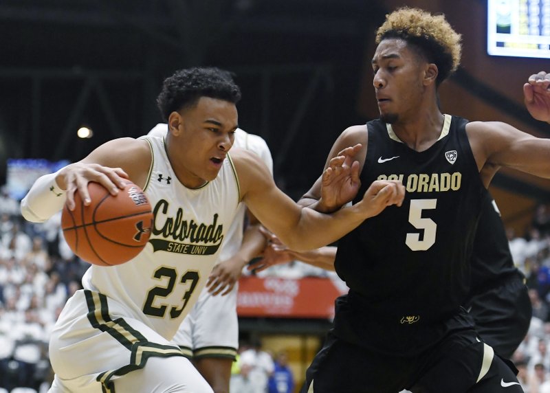 Colorado State guard John Tonje, left, drives past Colorado guard D'Shawn Schwartz in the first half of Friday's game in Fort Collins, Colo. - Photo by Bethany Baker of the Fort Collins Coloradoan via The Associated Press