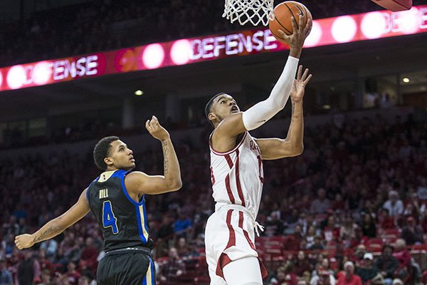 Arkansas guard Mason Jones goes up for a shot while Tulsa guard Isaiah Hill watches during a game Saturday, Dec. 14, 2019, in Fayetteville. 