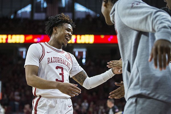 Arkansas guard Desi Sills is greeted by teammates during a game against Tulsa on Saturday, Dec. 14, 2019, in Fayetteville.