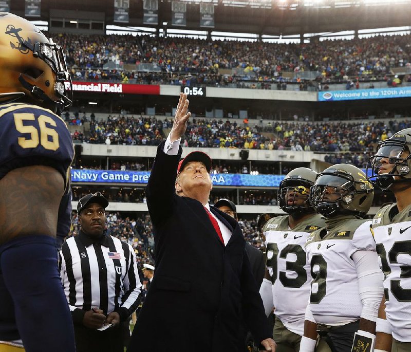 President Donald Trump presides over the coin toss Saturday at the Army-Navy college football game in Philadelphia. Trump gave locker-room pep talks and noted his policy change that allows military academy graduates to delay active duty to play professional sports. Video at arkansasonline.com/1215visit/. 
