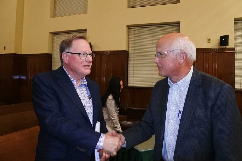 Sebastian County Human Resources Director Steve Hotz (left) chats with the county judge, David Hudson, after a Quorum Court special meeting Thursday.  