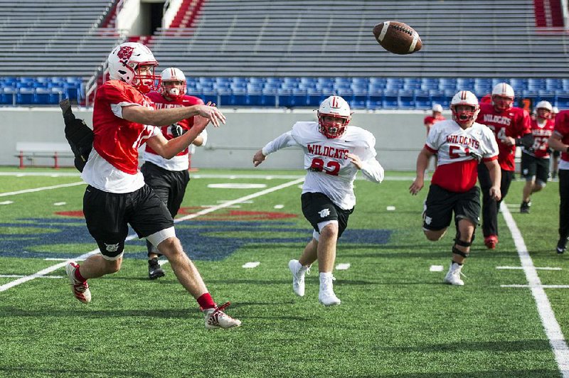 Harding Academy junior quarterback Caden Sipe throws during practice Thursday at War Memorial Stadium in Little Rock. Sipe has completed 213 of 292 passes for 3,502 yards with 56 touchdowns and 5 interceptions for the Wildcats, who will take on Osceola today for the Class 3A state title.