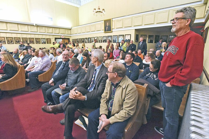 File Photo/NWA Democrat-Gazette/FLIP PUTTHOFF A standing room crowd, including Jeff Hottinger (right) of Lowell, hears comment in December 2018 at a Benton County Planning Board meeting regarding a proposed limestone quarry near Lowell. County planners will hear a new proposal for the quarry almost a year after it was tabled indefinitely.