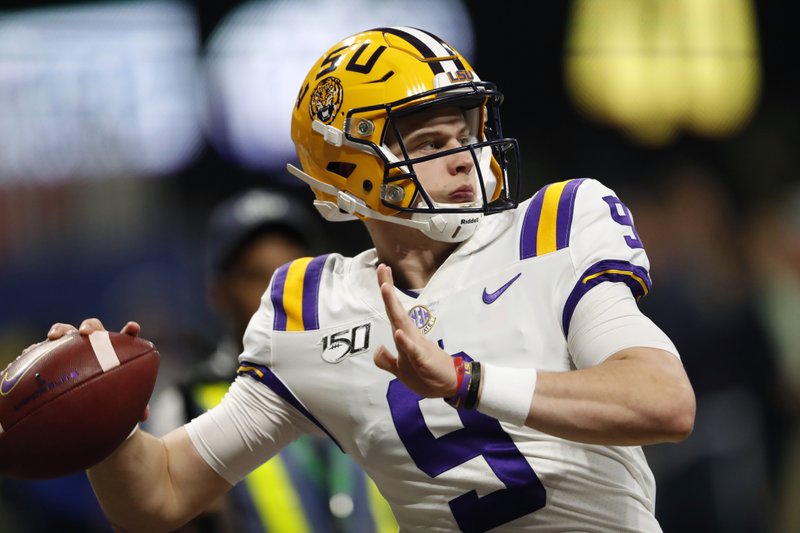 FILE - In this Dec. 7, 2019, file photo, LSU quarterback Joe Burrow (9) warms up before the Southeastern Conference championship NCAA college football game against Georgia, in Atlanta. Burrow is a unanimous selection as the offensive player of the year on The Associated Press All-Southeastern Conference football team, Monday, Dec. 9, 2019.(AP Photo/John Bazemore, File)