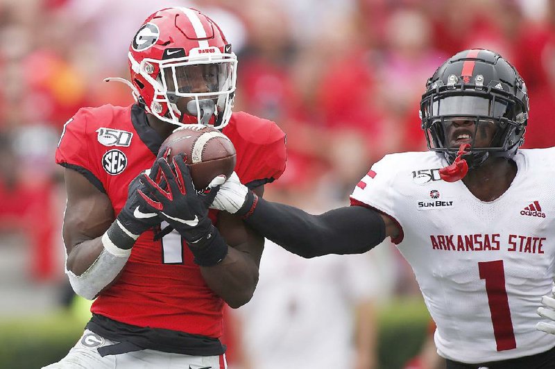 Arkansas State cornerback Jerry Jacobs (right) breaks up a pass intended for Georgia wide receiver George Pickens during a Sept. 14 game in Athens, Ga. Jacobs went down with a torn ACL in that game as one of several injuries to the Red Wolves’ defense this season.  