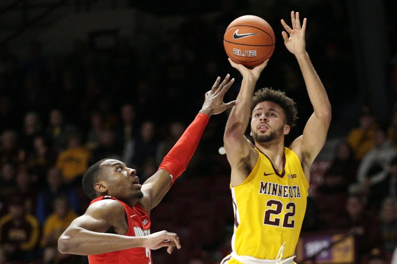 Minnesota guard Gabe Kalscheur (22) shoots over Ohio State guard D.J. Carton in the first half of an NCAA college basketball game Sunday, Dec. 15, 2019, in Minneapolis. (AP Photo/Andy Clayton-King)