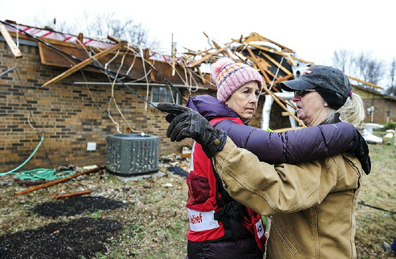 Cathie Morris (right) talks with Red Cross volunteer Laurie Howell on Tuesday in front of Morris’ storm-damaged house in Limestone County, Ala. Morris shared that her sister was killed in an April 2011 tornado not far from where Morris and Howell were standing. More photos are available at arkansasonline.com/1218south/
(AP/The Decatur Daily/Jeronimo Nisa)