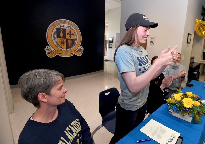 Lily DeSpain (second from left) of Haas Hall-Fayetteville gives a thumbs-up after signing a letter of intent Wednesday Dec. 18, 2019 to swim at the U.S. Naval Academy. DeSpain was joined by her mother (From left) Tiffany DeSpain, sister Corrine DeSpain and father Brennan DeSpain.