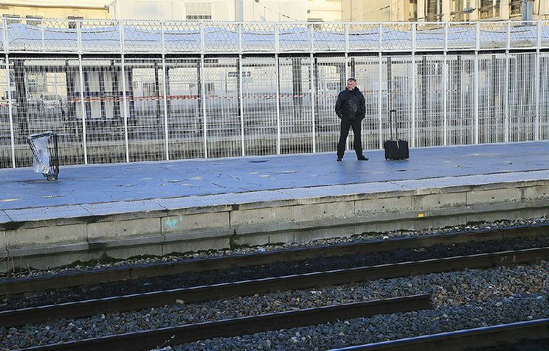 A lone commuter waits at the Gare du Nord train station in Paris on Wednesday. More photos at arkansasonline.com/1219strike/.
(AP/Michel Euler)