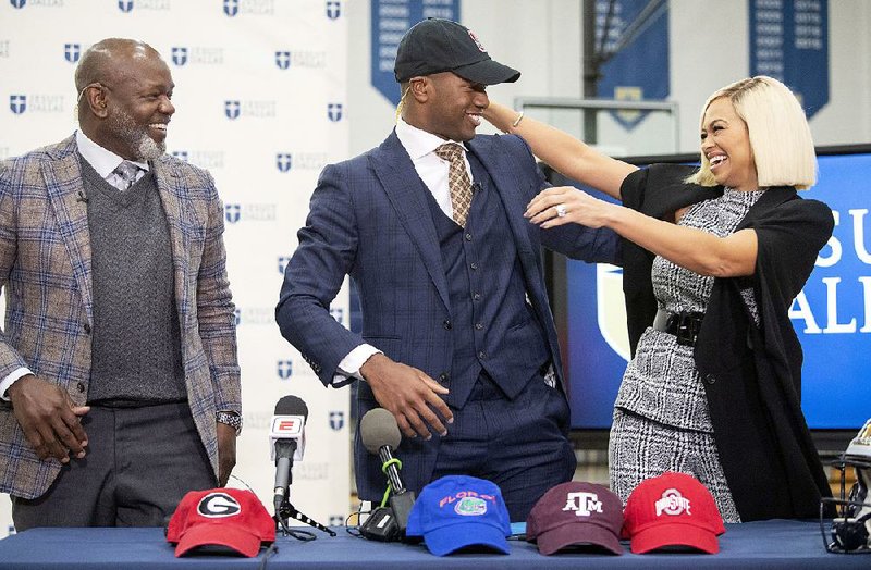 Congratulations in order Running back EJ Smith (left), son of NFL all-time leading rusher Emmitt Smith, gets a hug from his mother, Pat Smith, after announcing his commitment to play football at Stanford during a ceremony Wednesday in Dallas.
(AP/The Dallas Morning News/Jeffrey McWhorter)