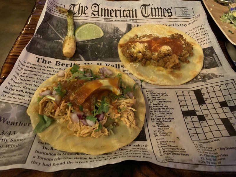 Diablos Tacos & Mezcaleria serves its Urban Tacos -- in this case, Tinga de Pollo (left) and Papa con Chorizo -- on fake newsprint with a crossword puzzle you can actually work.
(Arkansas Democrat-Gazette/Eric E. Harrison)