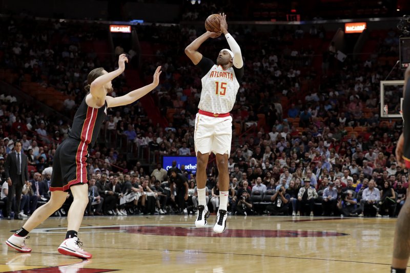 Atlanta Hawks guard Vince Carter (15) shoots a 3-pointer as Miami Heat forward Kelly Olynyk defends during the first half of a Dec. 10 game in Miami. - Photo by Lynne Sladky of The Associated Press