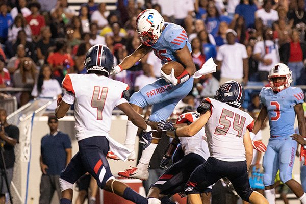 Little Rock Parkview tight end Erin Outley jumps over Marion defenders during a game Friday, Sept. 13, 2019, at War Memorial Stadium in Little Rock. 