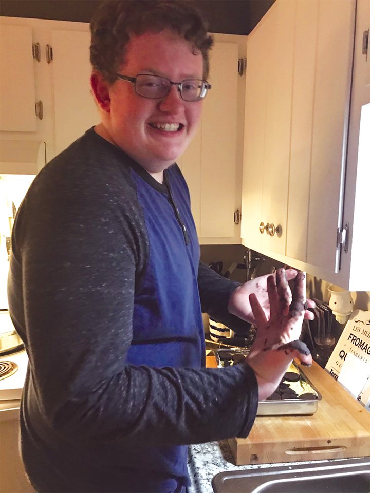 Logan Cole, a junior at Batesville High School, is in the test kitchen preparing his Oreo Lasagna. This is one of the recipes in the class’ Chocolate Thunder cookbook.