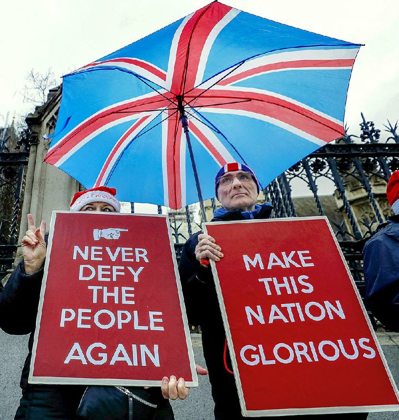 Pro-Brexit demonstrators gather Friday outside the British Parliament in London. More photos at arkansasonline.com/1221uk/.  