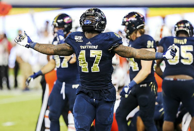 Florida International linebacker Chris Whittaker celebrates after a turnover during the Panthers’ victory over Miami on Nov. 23. The Panthers’ defense ranks among the nation’s best against the pass entering today’s Camellia Bowl against Arkansas State.