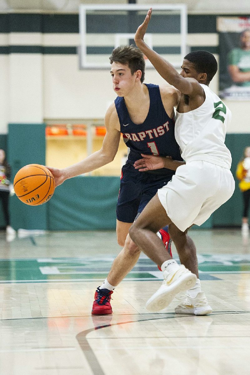 Baptist Prep’s Hudson Likens (left) tries to dribble past Chris Smith of Episcopal Collegiate during Friday night’s game in Little Rock. See more photos at arkansasonline.com/1221methoepisc.
