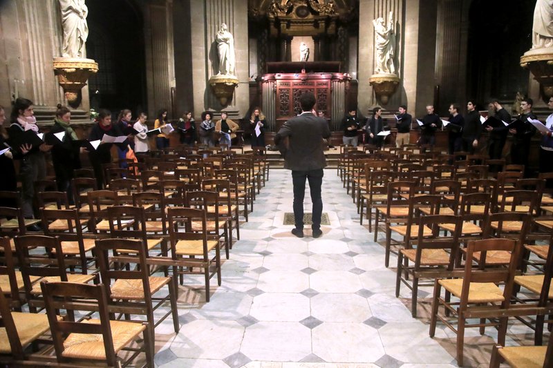 Notre Dame cathedral choir's director Henri Chalet directs the Notre Dame choir during a rehearsal on Dec. 16 at the Saint Sulpice church in Paris. Notre Dame Cathedral kept holding services during two world wars as a beacon of hope amid bloodshed and fear. It took a fire in peacetime to finally stop Notre Dame from celebrating Christmas Mass for the first time in more than two centuries. -AP Photo/Michel Euler