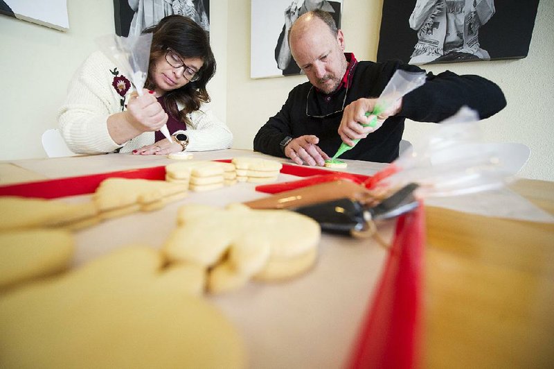 FILE - Meredith Wright (left) and Brian Kelton of Sherwood decorate cookies at Dempsey Bakery in Little Rock on December 21, 2019. The bakery was still open Thursday and keeping its regular hours. (Arkansas Democrat-Gazette/Jeff Gammons)