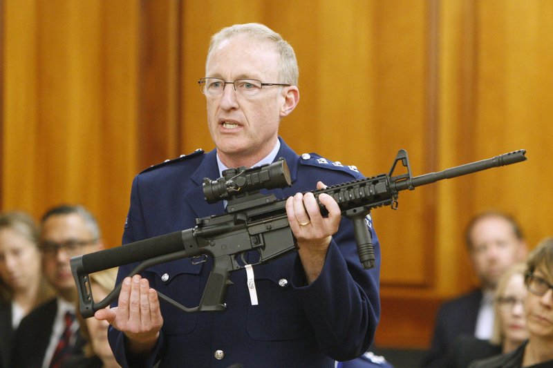 FILE - In this April 2, 2019, file photo, police acting superintendent Mike McIlraith shows New Zealand lawmakers an AR-15 style rifle similar to one of the weapons a gunman used to slaughter 51 worshippers at two Christchurch mosques, in Wellington, New Zealand. New Zealand authorities said Saturday, Dec. 21, 2019, their country will be a safer place after gun owners handed in more than 50,000 guns during a buyback program after the government banned assault weapons. But critics say the process was flawed and many owners have illegally stashed their guns. (AP Photo/Nick Perry, File)