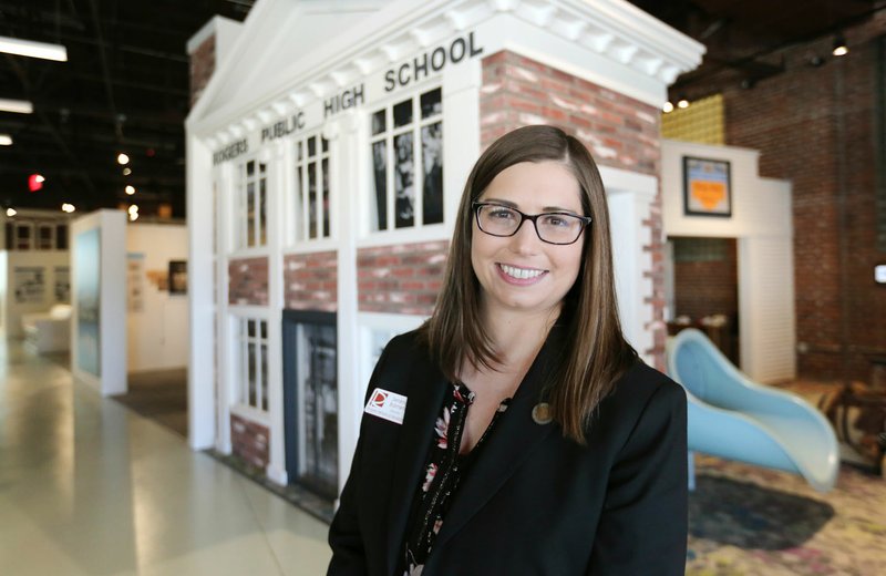 NWA Democrat-Gazette/DAVID GOTTSCHALK Serena Barnett, director of the Rogers Historical Museum, stands Wednesday in the entrance of the museum. "My heart is with this museum particularly. It is a dream come true for me to come back here to work for this museum in my hometown," she said.