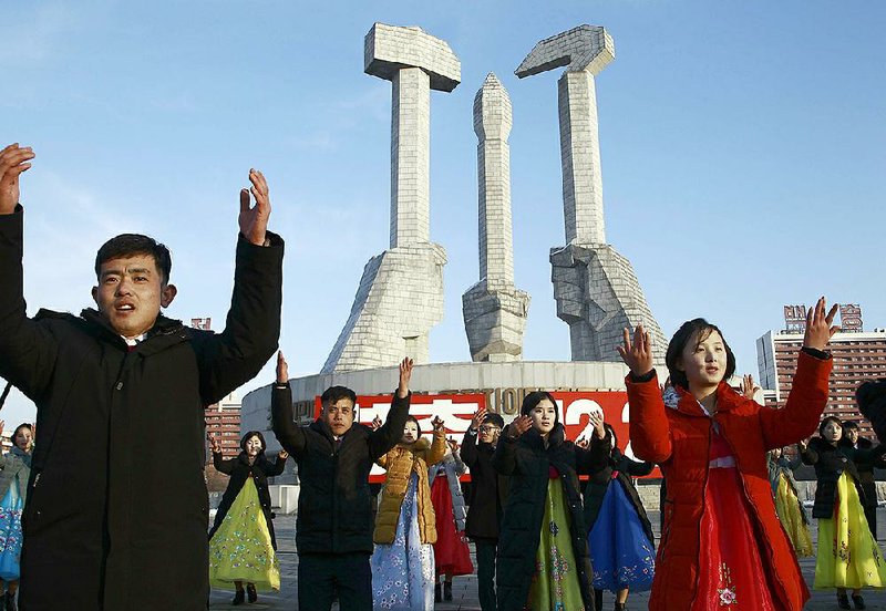 North Koreans take part in a public dance Tuesday in Pyongyang around the Monument to Party Founding on the 28th anniversary of the start of Chairman Kim Jong Il’s leadership of the Korean People’s Army. U.S. analysts say North Korea could be poised to test-fi re a long-range missile.
(AP/Jon Chol Jin)