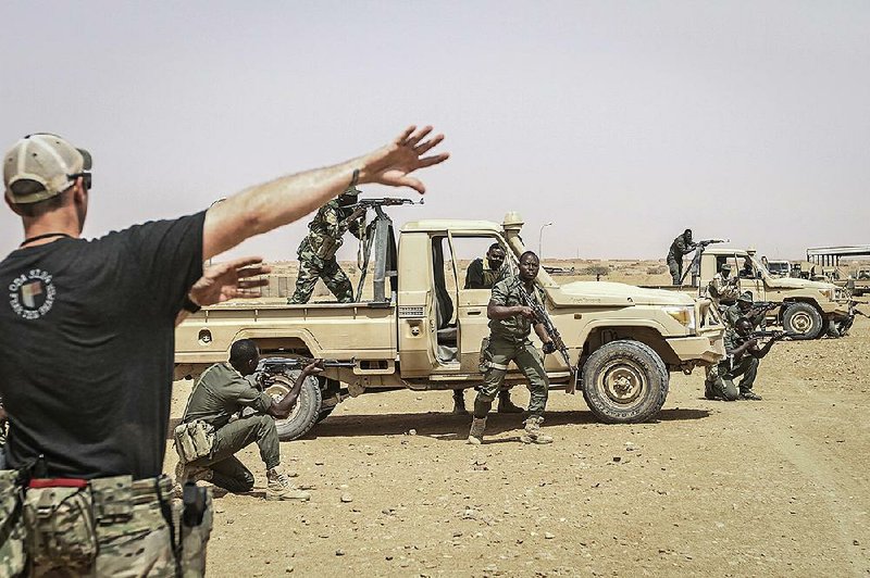 A U.S. Special Forces sergeant directs troops for Niger during a training exercise in Agadez, Niger, in April. U.S. officials reportedly are considering a large-scale drawdown of American forces in West Africa, including abandoning a recently built drone base near Agadez.
(The New York Times/Tara Todras-Whitehill)