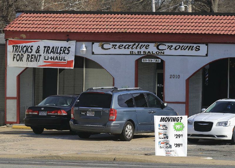 Signs advertising U-Haul rental hang in front of a barber shop Tuesday Dec. 24, 2019 on Pike Ave. in North Little Rock. The business owner who has been operating the barbershop and U-Haul rental business was told to cease rental operations after the city council voted down his special use request. 
(Arkansas Democrat-Gazette/Staton Breidenthal)  