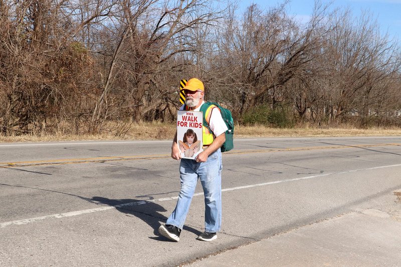 LYNN KUTTER ENTERPRISE-LEADER Ralph Nesson, executive director of NWA Books for Kids, walked from Fayetteville to Siloam Springs last week and then made the trip back home to raise money for the organization, which promotes family literacy and encourages parents to read with their children.