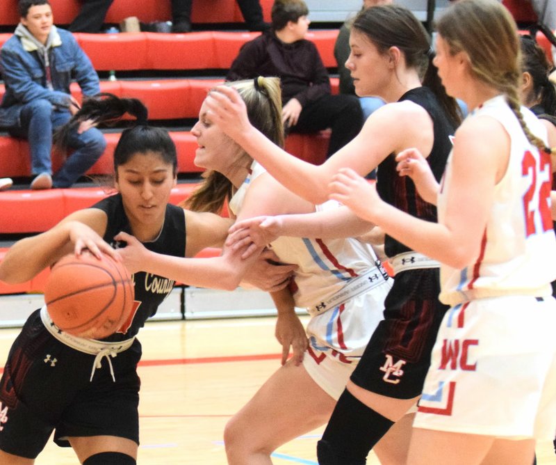 RICK PECK/SPECIAL TO MCDONALD COUNTY PRESS McDonald County's Rita Santillan steals the ball from a Webb City player during the Lady Mustangs 52-44 loss on Dec. 17 at Webb City High School.