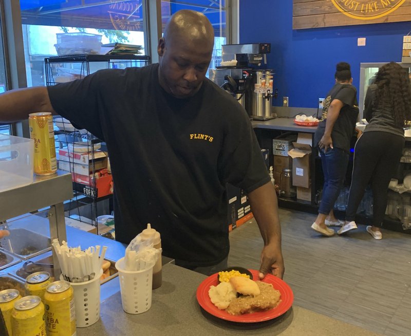 Flint Fannoy plates an order at Flint's Just Like Mom's. He's opening a second outlet next week near the state Capitol.
(Arkansas Democrat-Gazette/Jerry McLeod)