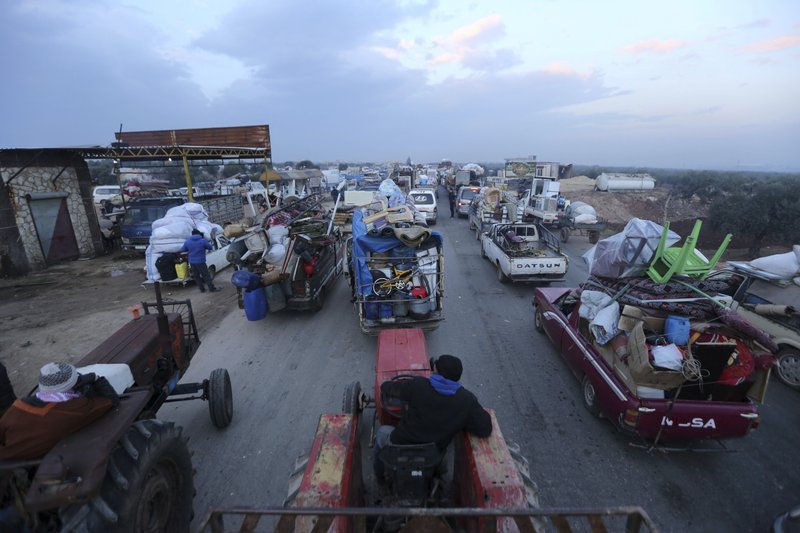 Truckloads of civilians flee a Syrian military offensive in Idlib province on the main road near Hazano, Syria, on Tuesday. Syrian forces launched a wide ground offensive last week into the northwestern province of Idlib, which is dominated by al-Qaida-linked militants. The United Nations estimates that some 60,000 people have fled from the area, heading south, after the bombings intensified earlier this month. - AP Photo/Ghaith al-Sayed