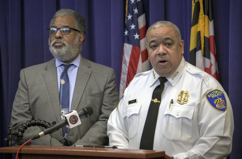 In this Friday, Dec. 20, 2019 file photo Baltimore Police Commissioner Michael Harrison announces support for a pilot program that uses surveillance planes over the city to combat crime in Baltimore. City solicitor Andre Davis is at left. 
(Jerry Jackson/The Baltimore Sun via AP)