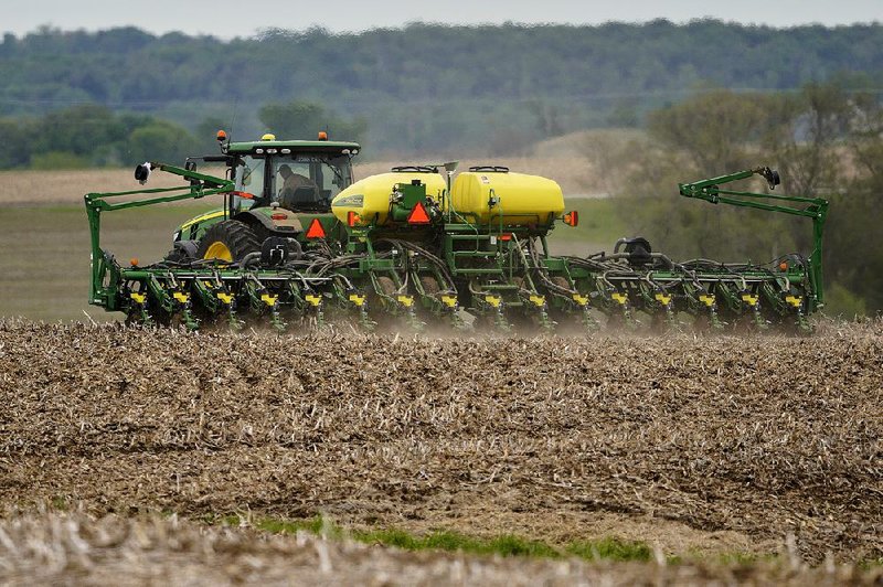 A farmer plants soybeans near Springfield, Neb., in late May. China, which cut off purchases of U.S. soybeans after President Donald Trump raised tariffs on Chinese goods, ramped up imports of American soybeans in November as an interim trade deal took shape. But skeptics are questioning just how much China has actually committed to buy.
(AP/Nati Harnik)