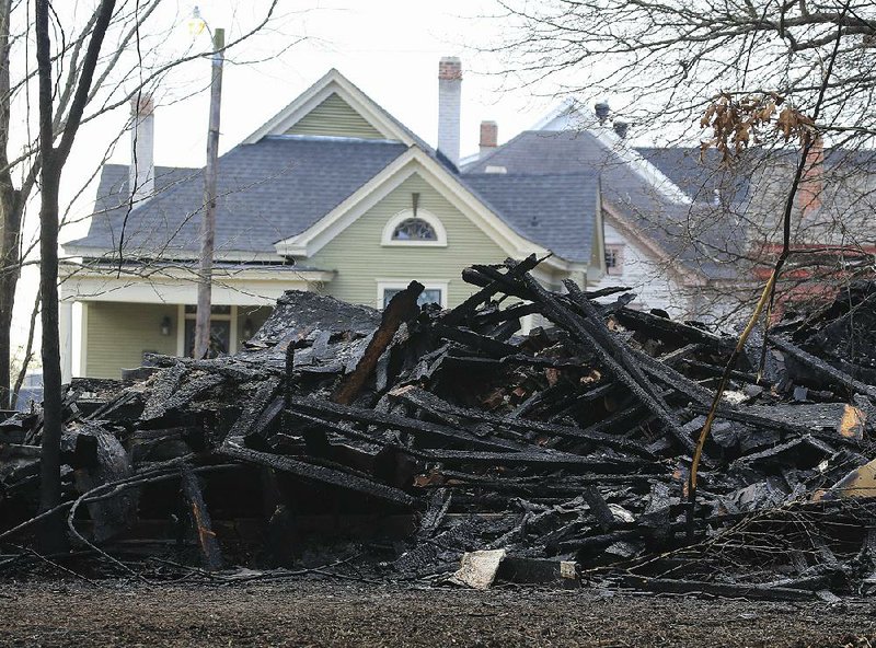 The Schmelzer House, built circa 1907, at 1414 Park Lane in Little Rock, is reduced to a charred pile Thursday after a fire Wednesday night.
(Arkansas Democrat-Gazette/Staton Breidenthal)