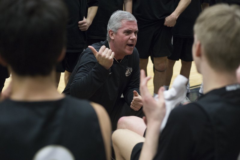 In this March 2, 2019 file photo, Bentonville High School head coach Dick Rippee talks to his players during a basketball game at Bentonville West High School in Centerton.