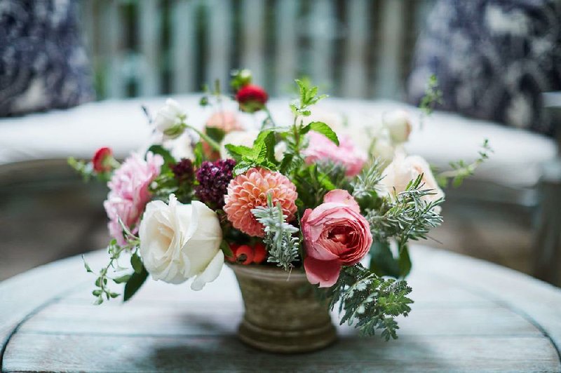 A Cathy Graham arrangement includes dahlias, garden roses and ranunculus plus fragrant rosemary, which signifies remembrance. It would make a nice Mother’s Day or get-well arrangement. 