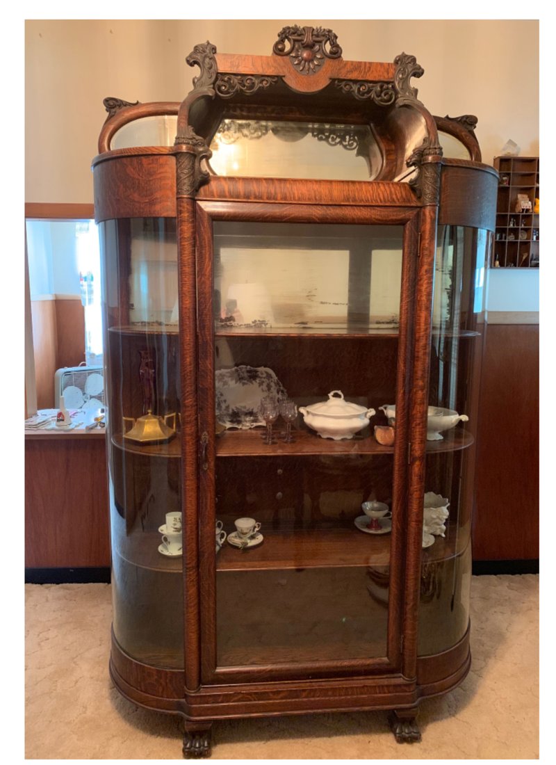Does this curved glass cabinet have a maker's label? (TNS/Handout)