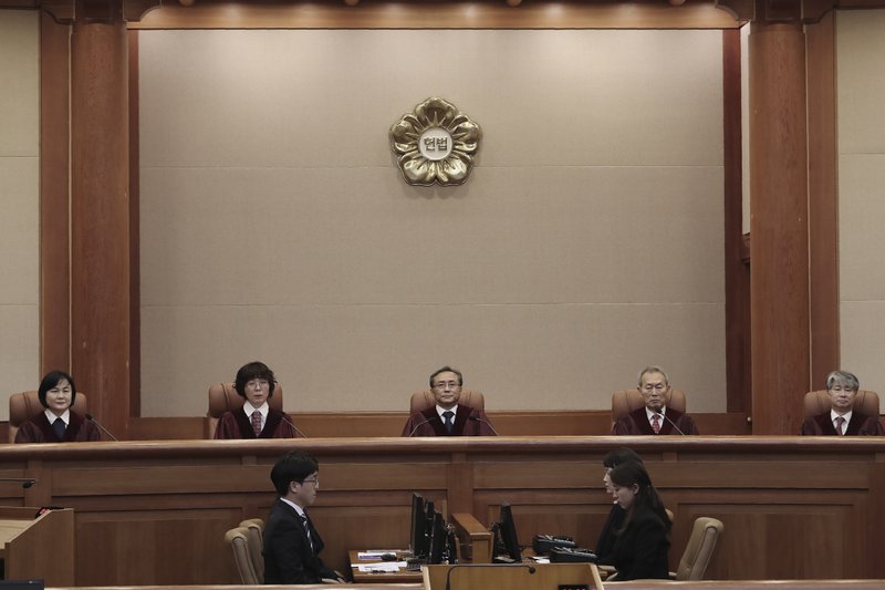 South Korea's Constitutional Court Chief Justice Yoo Nam-seok, top center, and other judges sit before the judgment at the Constitutional Court in Seoul, South Korea, Friday, Dec. 27, 2019. 
(AP Photo/Ahn Young-joon)