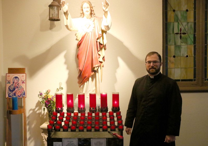 Father Edward D'Almeida poses for a photo in the Holy Redeemer Catholic Church Dec. 10. D'Almeida has been the priest in El Dorado for five years.