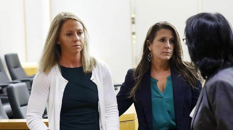 Former Dallas police officer Amber Guyger (left) leaves the courtroom during a break in morning proceedings in her murder trial, Tuesday, Sept. 24, 2019, in Dallas. Guyger is accused of shooting her unarmed black neighbor in his Dallas apartment.  
(Tom Fox/The Dallas Morning News via AP, Pool)