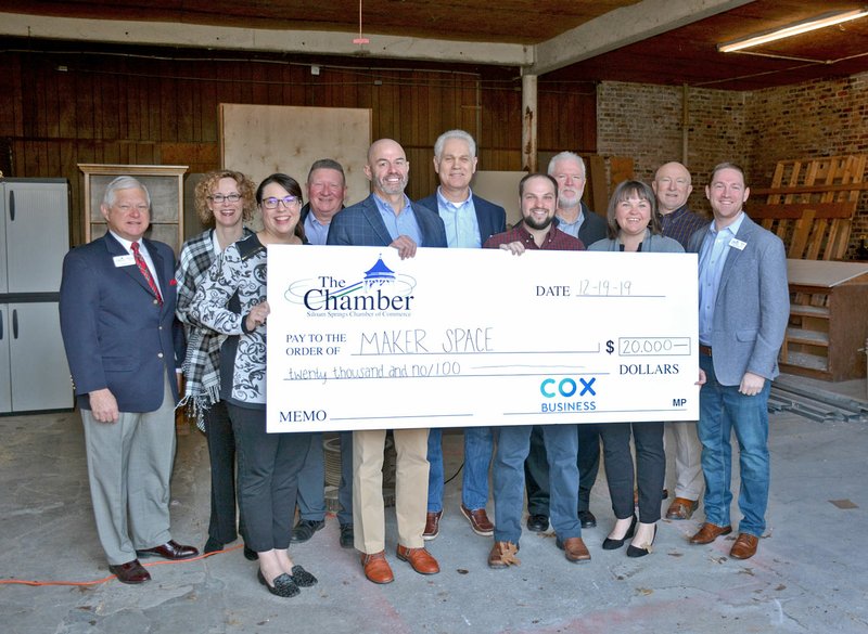 Janelle Jessen/Siloam Sunday Cox Communications donated $20,000 to the Siloam Springs Chamber of Commerce on Dec. 19 to fund a maker space. Pictured are Wayne Mays (left), retiring president and CEO of the Chamber of Commerce; Cheri Harrison, Cox media consultant; Angela DeLille, Cox manager of government affairs; Tim McCord, market president for Generations Bank and past Chamber board chair; Curt Stamp, Cox vice president of government affairs; James Barnett, CEO of DaySpring and Chamber board member; Nathan Reed, Chamber vice president; Phillip Patterson, city administrator; Whitney Yoder, Cox manager of public affairs; Reid Carroll, city board member; and Tyler Dees, current Chamber board chair.