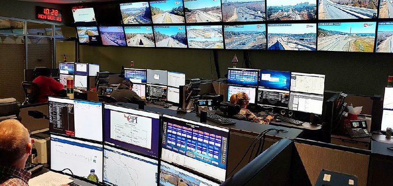 A bank of 20 large screens showing traffic conditions on major routes dominates the main room of the state Traffic Management Center on the basement floor of the Arkansas Department of Transportation headquarters in Little Rock.  