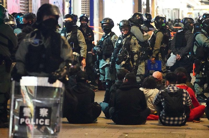 Police detain people Wednesday in Hong Kong during a New Year’s Day protest march. Tens of thousands of people joined the march, which police initially allowed to proceed before rescinding permission hours after it began, citing violence and vandalism.
(AP/Vincent Yu)